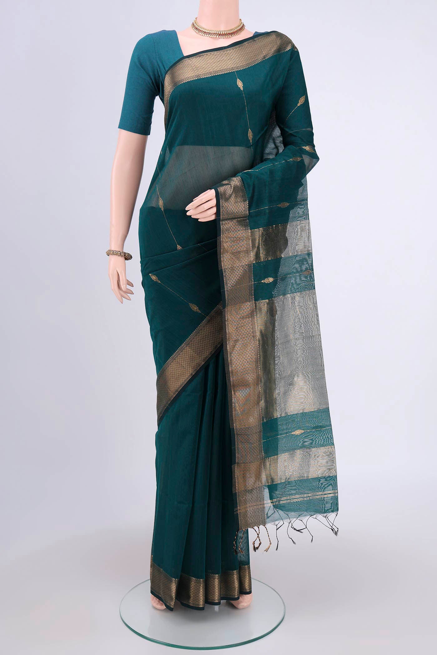 Peacock Blue Maheshwari Silk Cotton Saree with Zari Butta on the body and Zari Border.  displayed on a mannequin