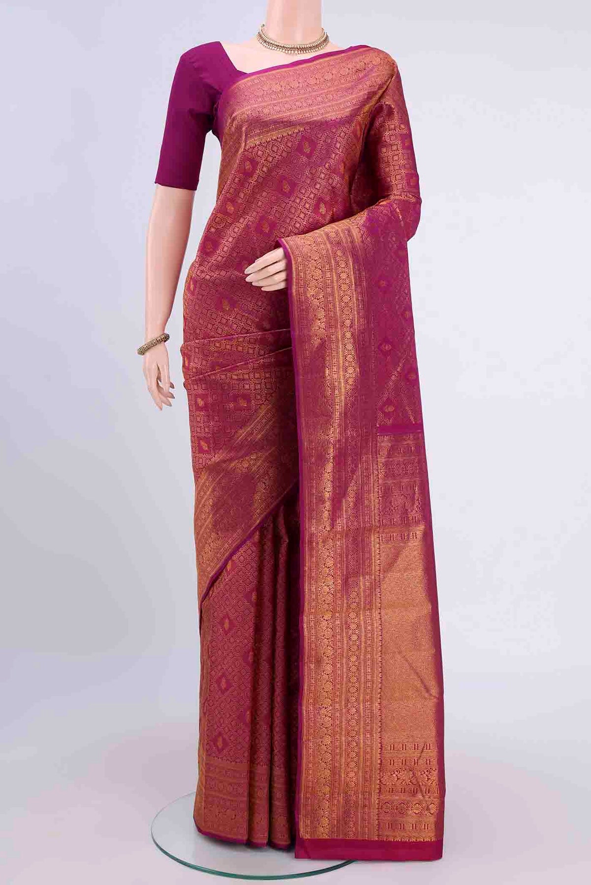 Magenta Kanchipuram Silk Saree with Zari Brocade on the body and Zari Border displayed on a mannequin