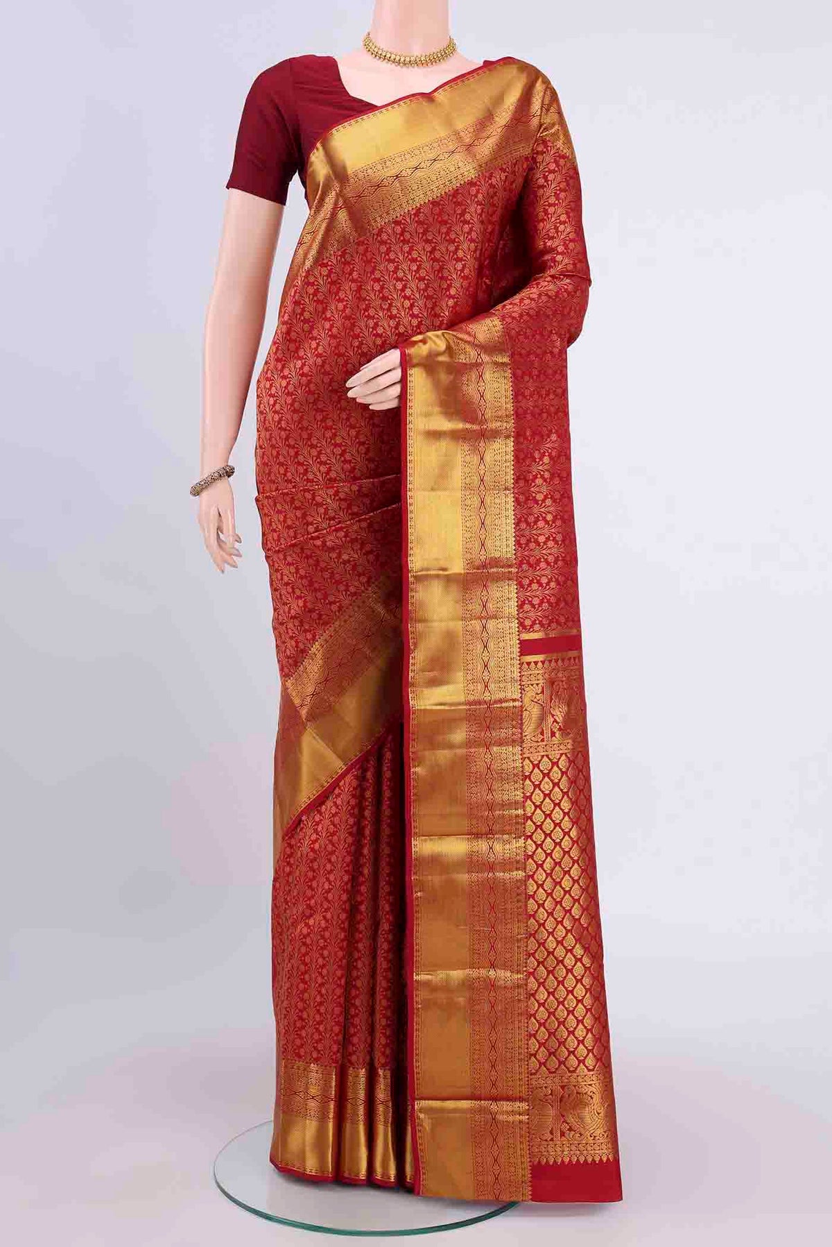 Red Kanchipuram Silk Saree with Zari Brocade on the body and Zari Border displayed on a mannequin