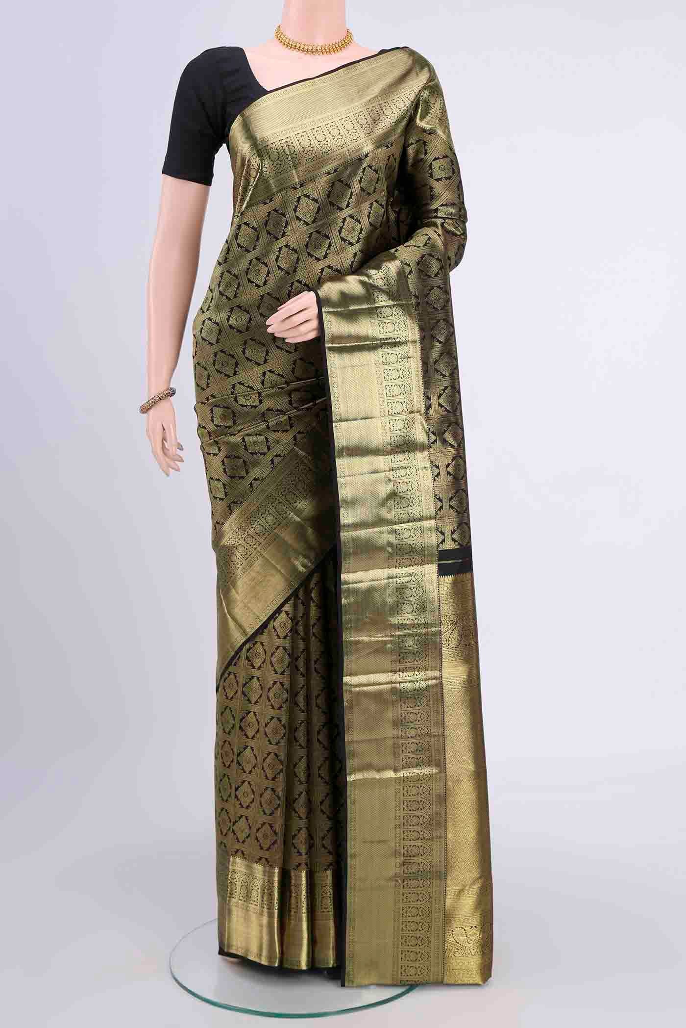 Black Kanchipuram Saree with Zari Brocade on the body and Zari Border displayed on a mannequin