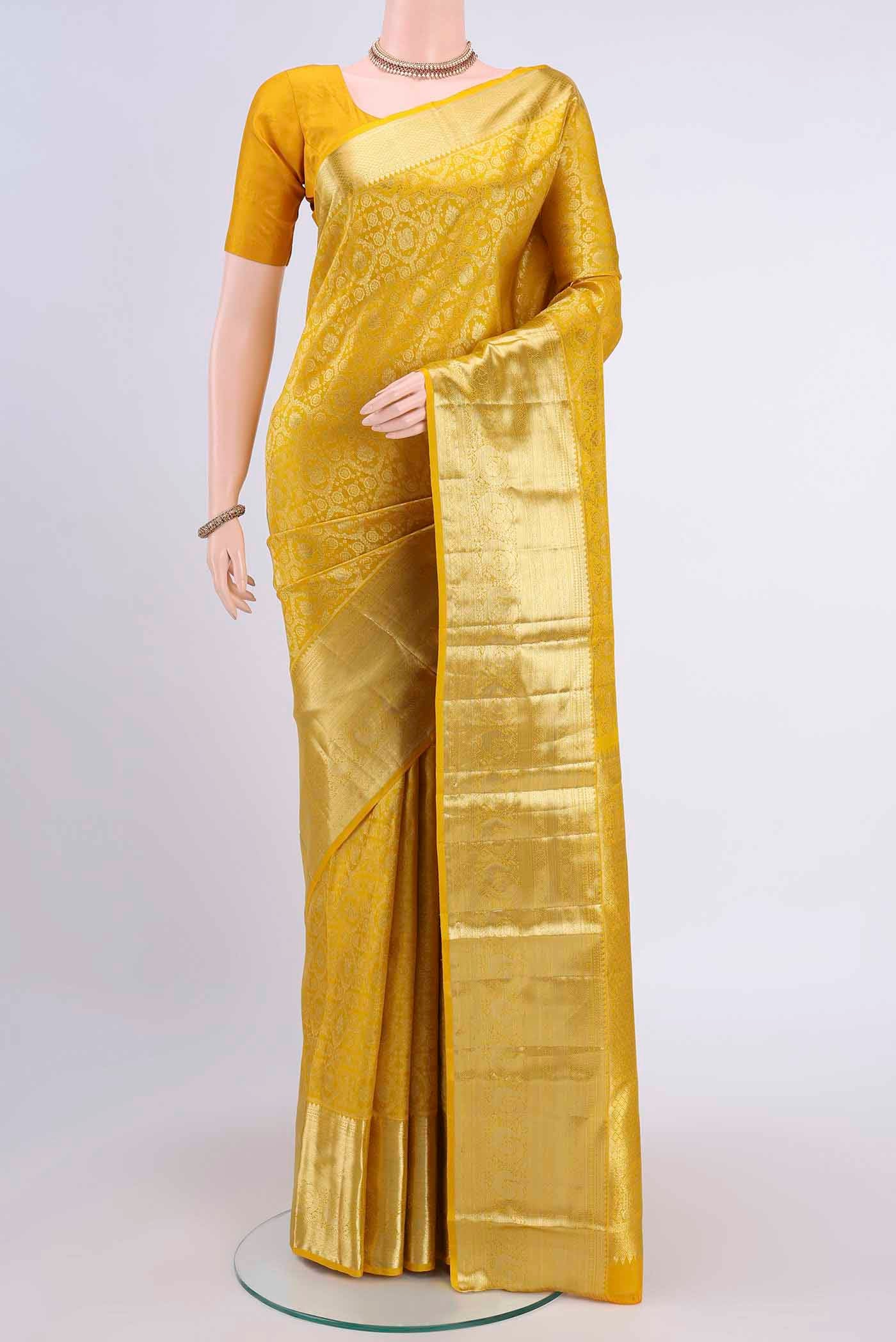 Lemon Yellow Kanchipuram Saree with Zari Brocade on the body and Zari Border displayed on a mannequin