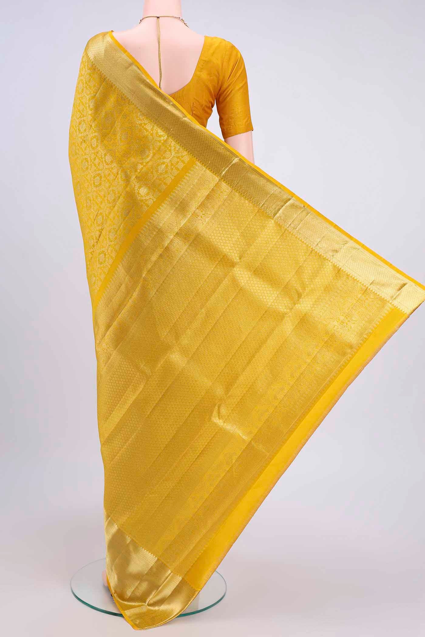Flat view of Lemon Yellow Kanchipuram Saree with Zari Brocade on the body and Zari Border