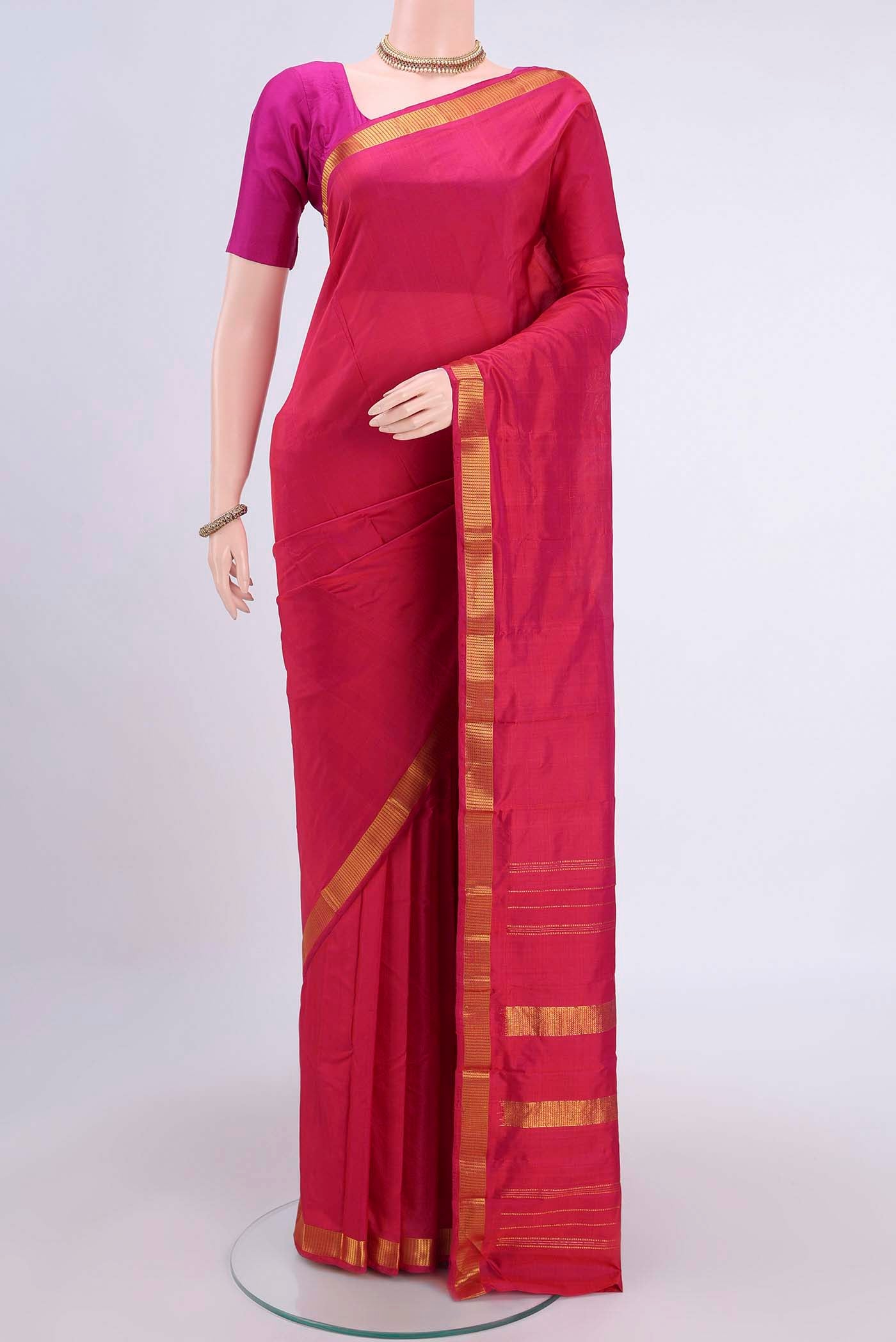 Rani Pink Kanchipuram Silk Saree with Plain Body and Zari Border displayed on a mannequin