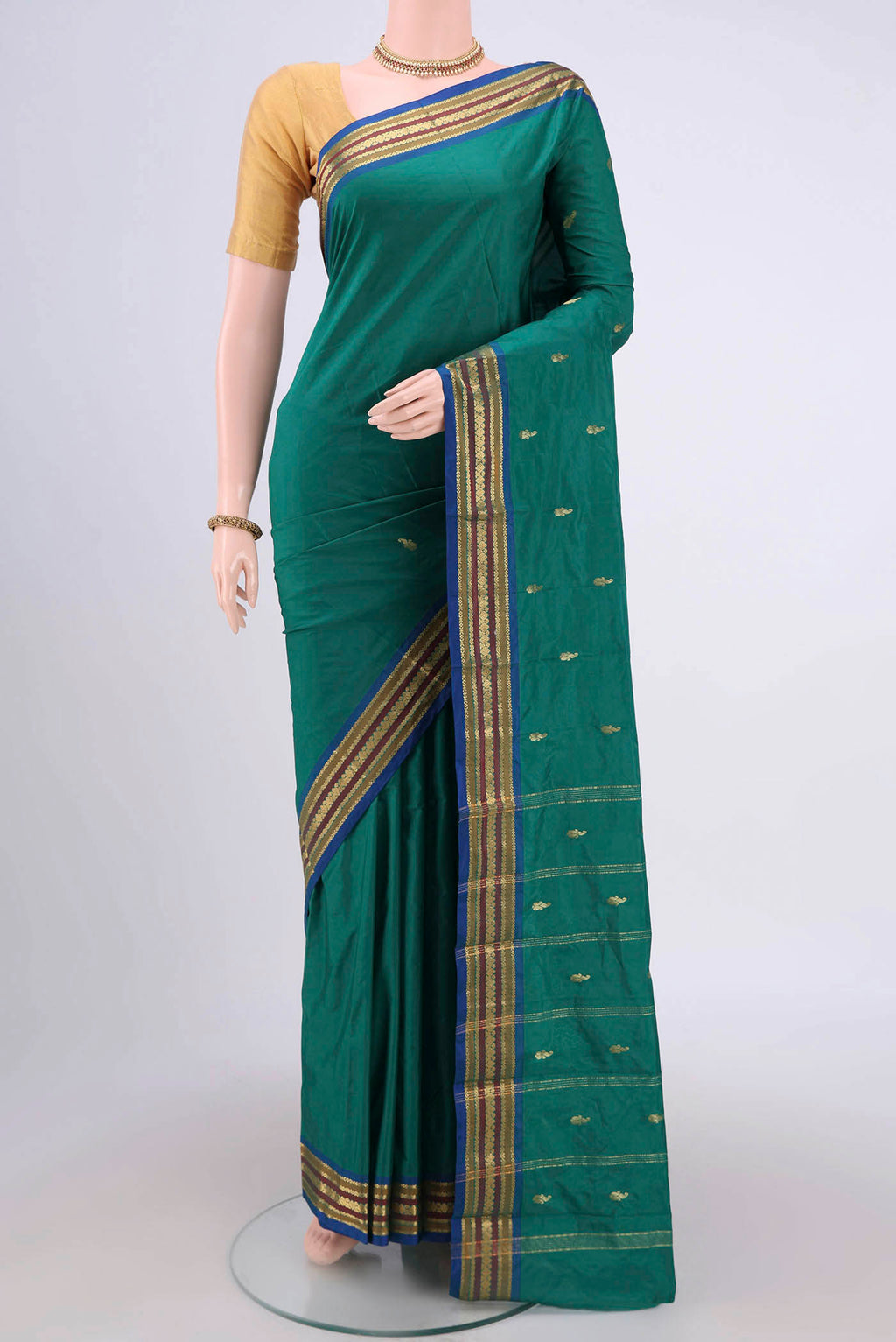 Green Blended Bangalore Silk Saree with Zari Butta on the body and Zari Border.  displayed on a mannequin