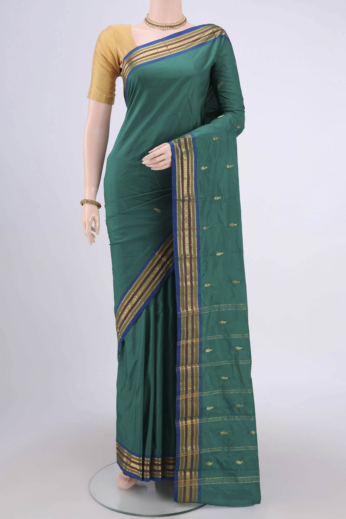 Green Blended Bangalore Silk Saree with Zari Butta on the body and Zari Border.  displayed on a mannequin