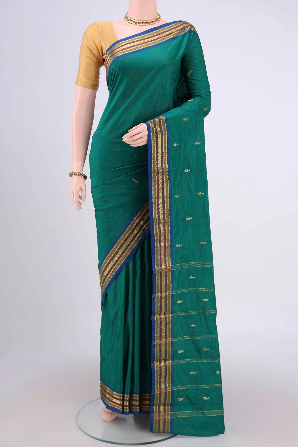 Green Blended Bangalore Silk Saree with Zari Butta on the body and Zari Border.  displayed on a mannequin