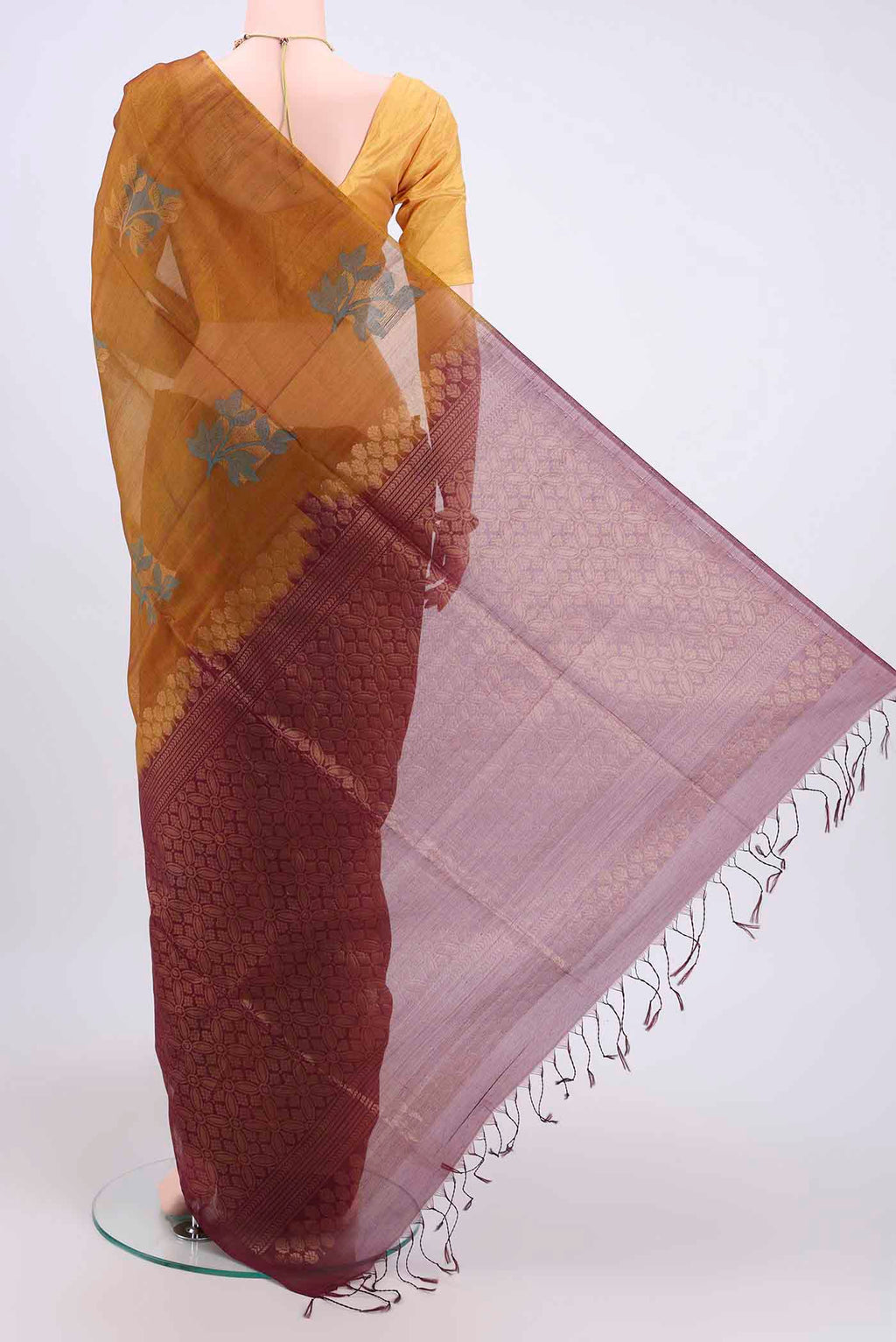 Flat view of Mustard Kora Cotton Saree with Zari Butta on the body and Zari Border. 