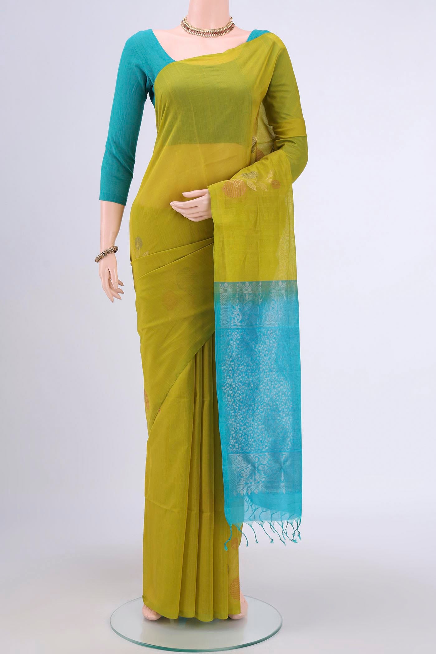 Acid Green Kora Cotton Saree with Zari Butta on the body and Zari Border.  displayed on a mannequin