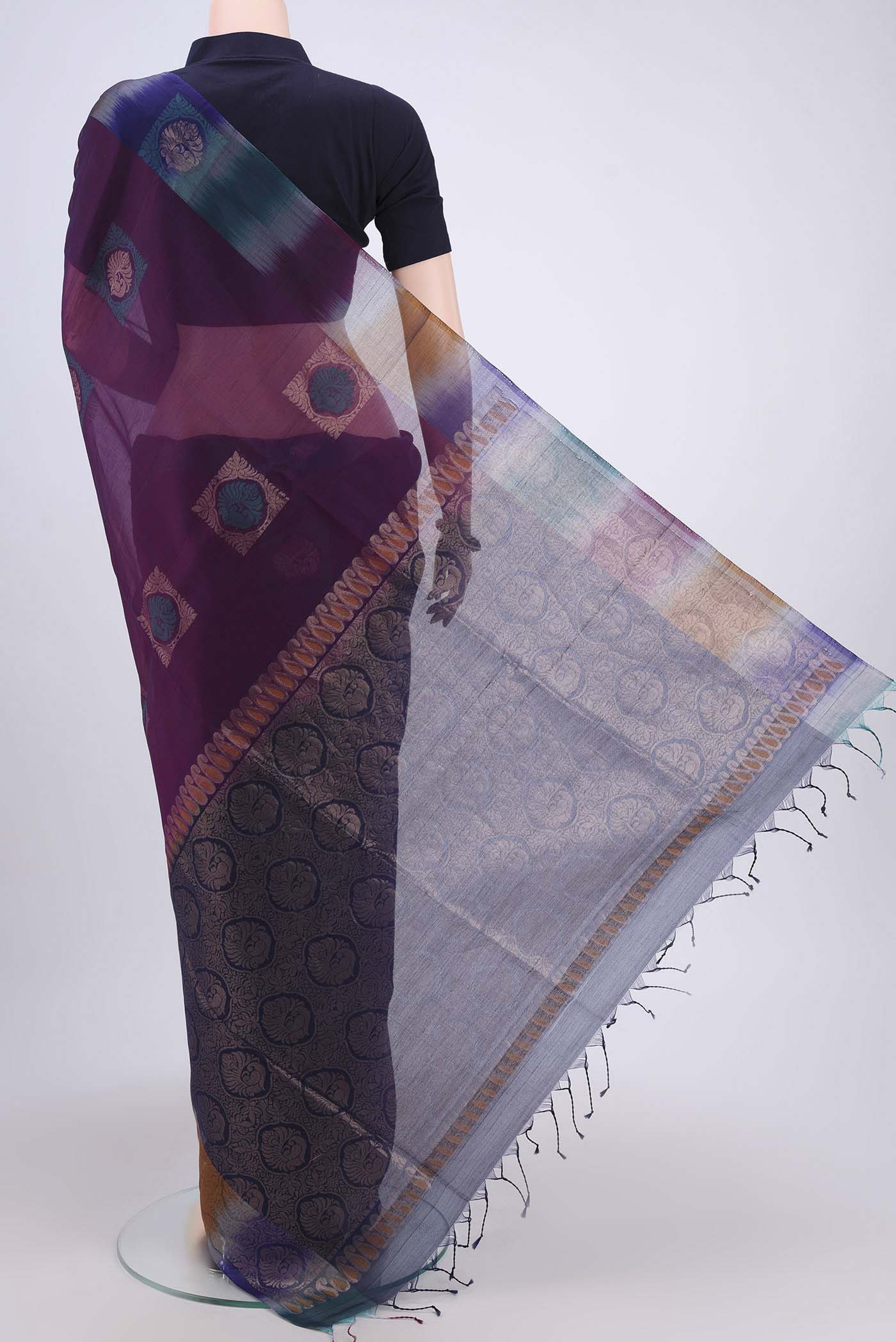 Flat view of Dark Mauve Kora Cotton Saree with Zari Butta on the body and Zari Border. 