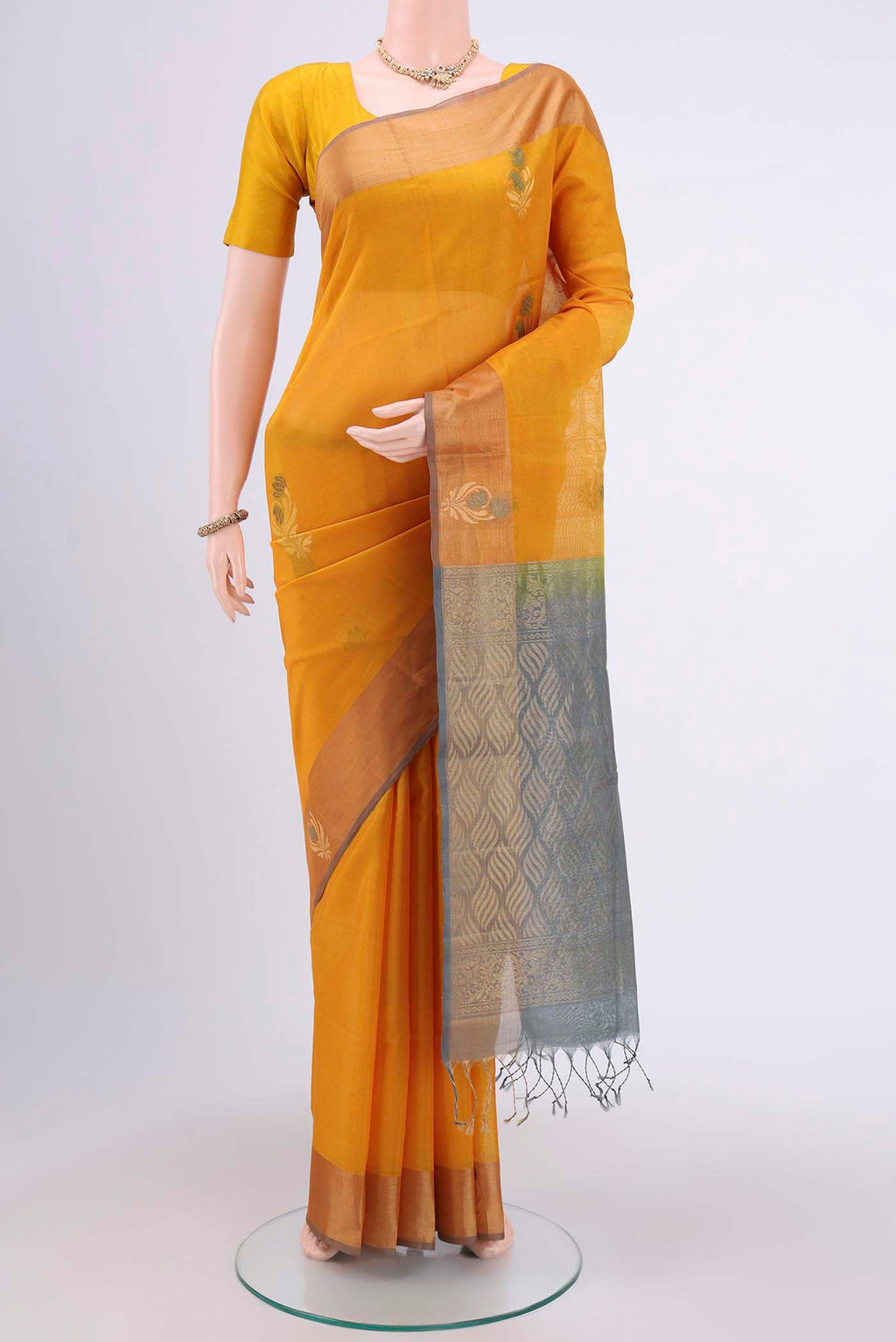 Yellow Kora Cotton Saree with Zari Butta on the body and Zari Border.  displayed on a mannequin