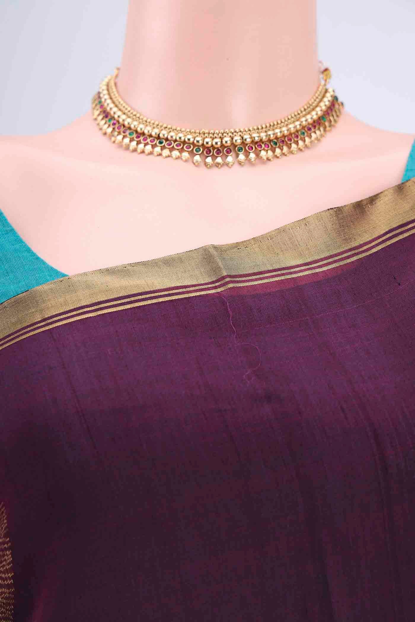 Border image of Burgundy Kora Cotton Saree with Zari Butta on the body and Zari Border. 