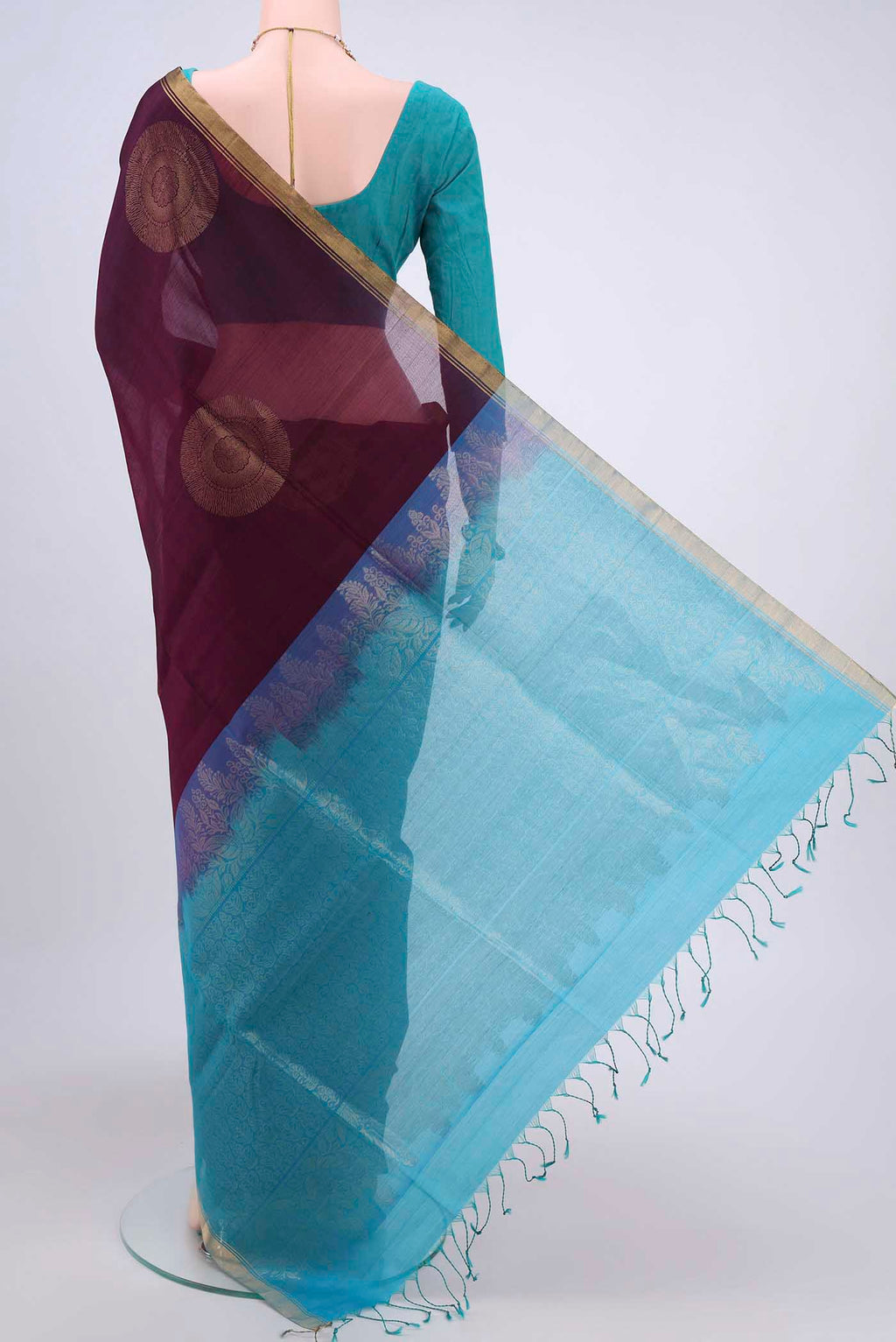 Flat view of Burgundy Kora Cotton Saree with Zari Butta on the body and Zari Border. 
