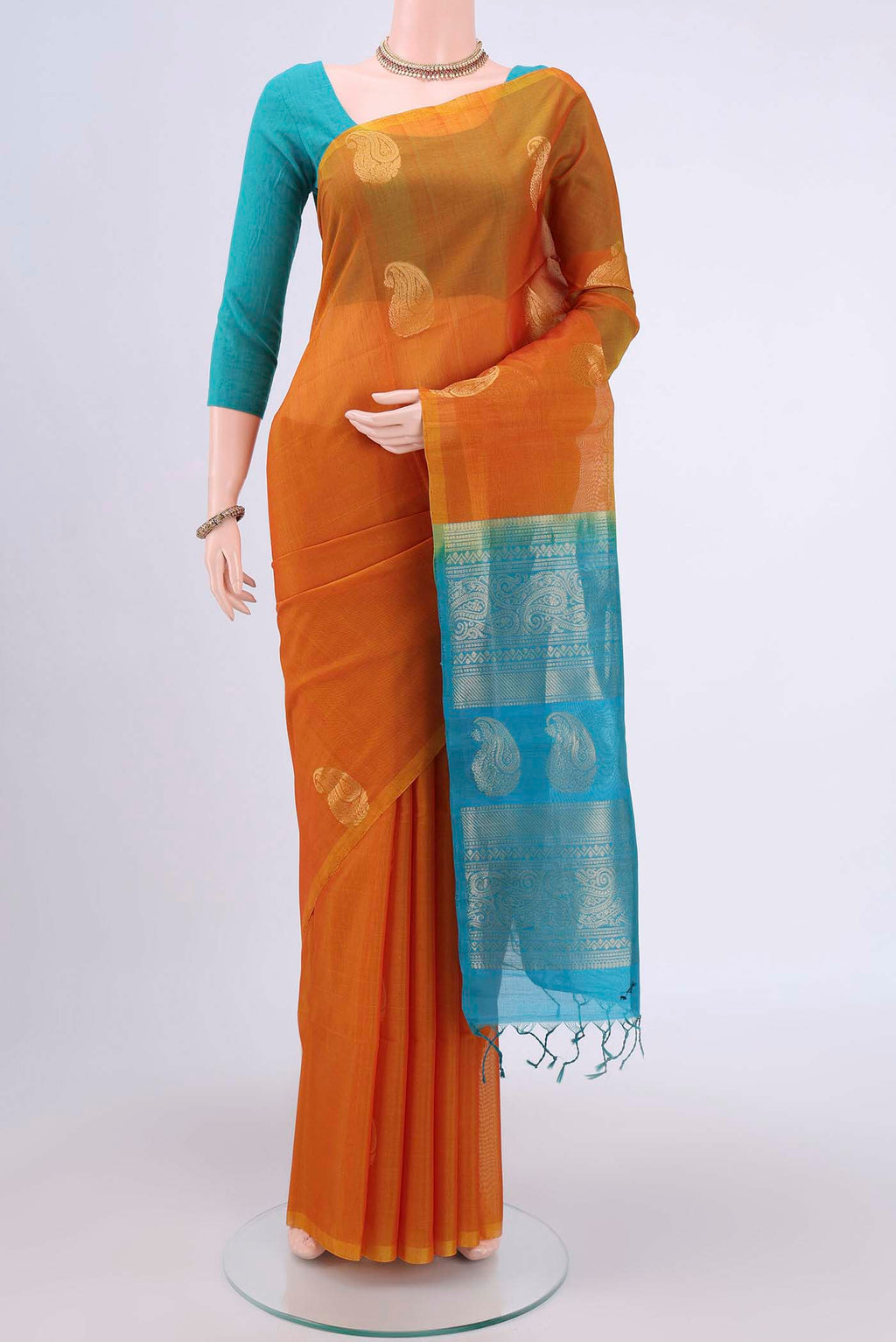 Mustard Kora Cotton Saree with Zari Butta on the body and Zari Border.  displayed on a mannequin