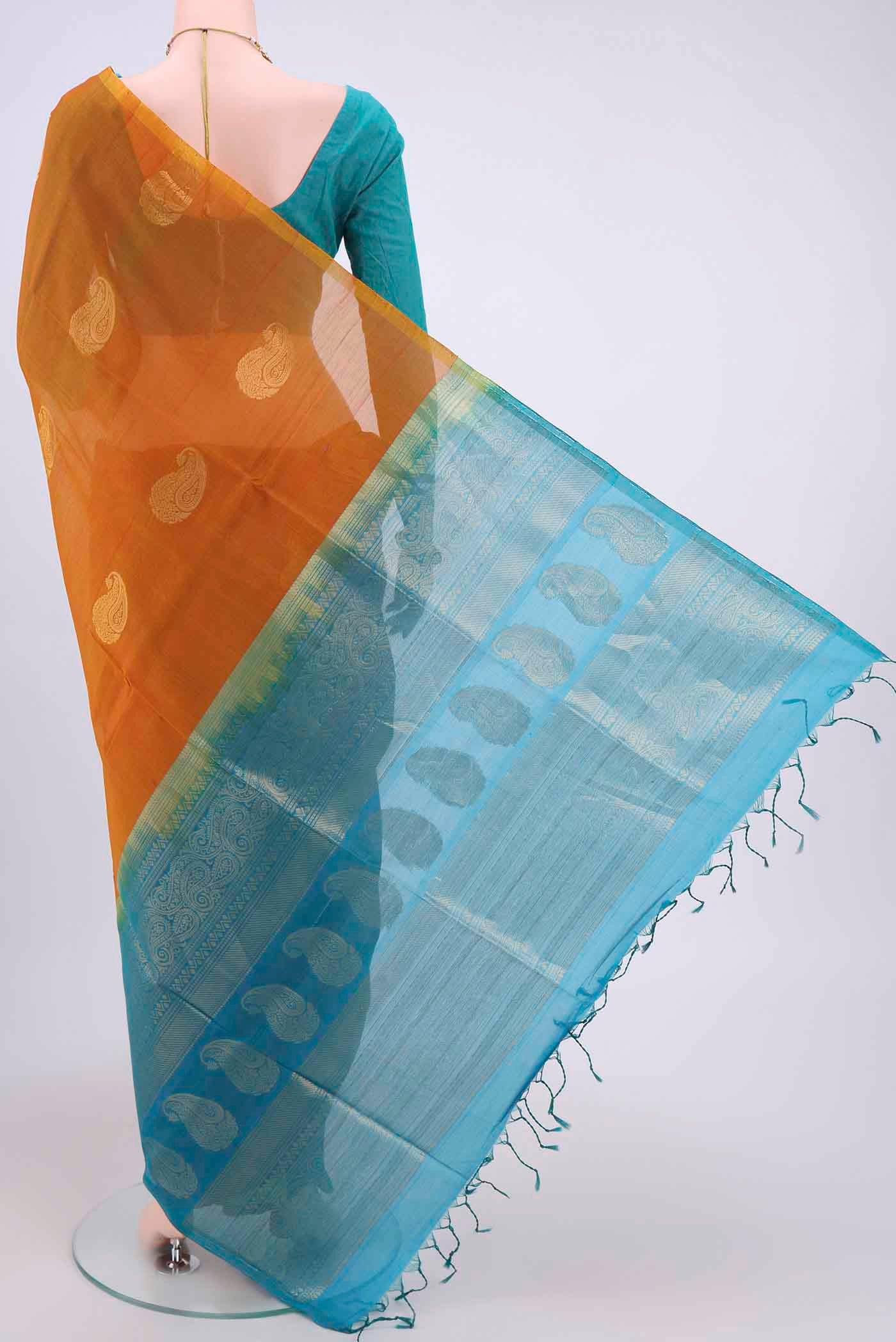 Flat view of Mustard Kora Cotton Saree with Zari Butta on the body and Zari Border. 