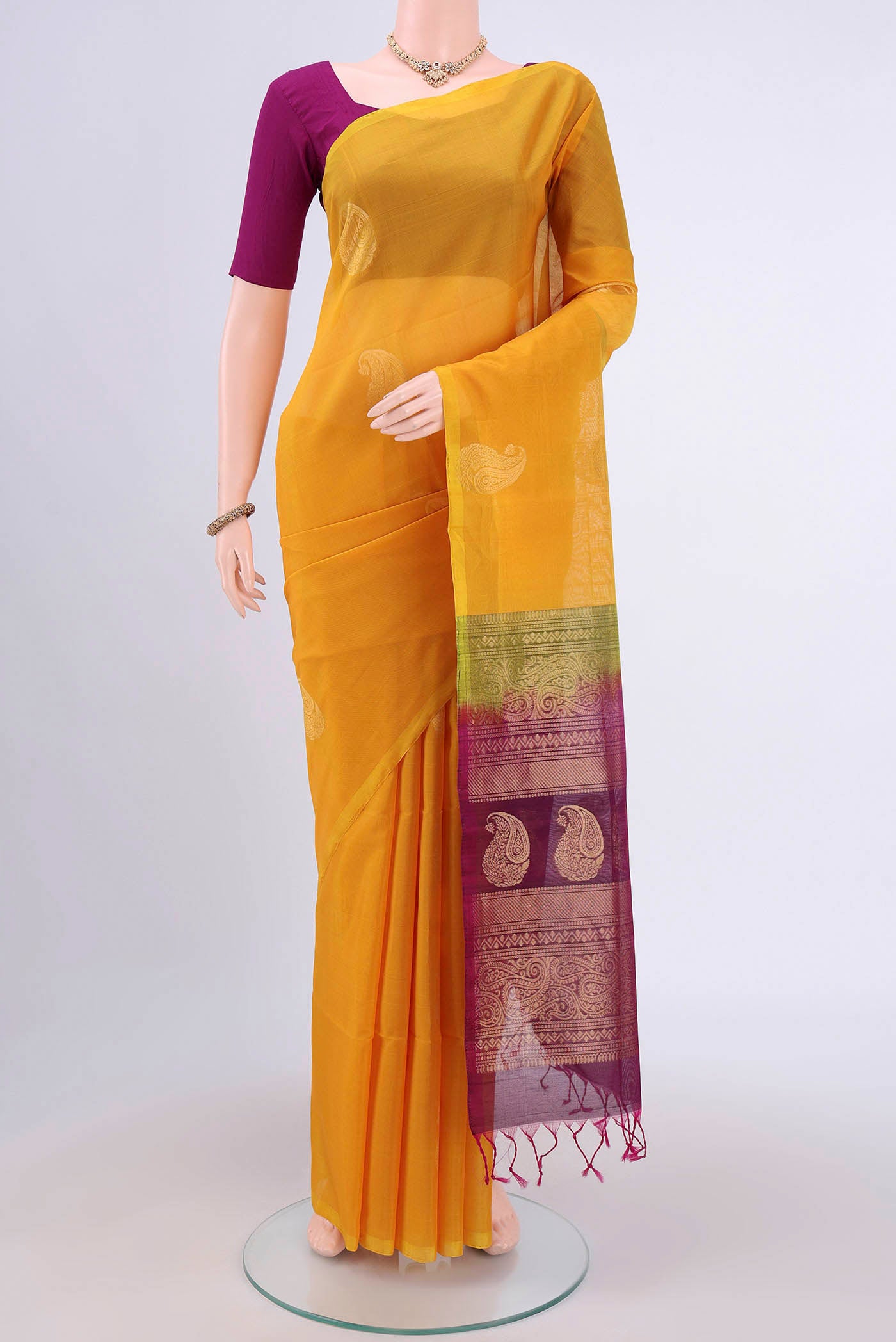 Yellow Kora Cotton Saree with Zari Butta on the body and Zari Border.  displayed on a mannequin