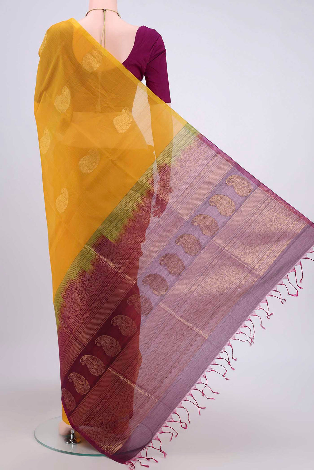 Flat view of Yellow Kora Cotton Saree with Zari Butta on the body and Zari Border. 