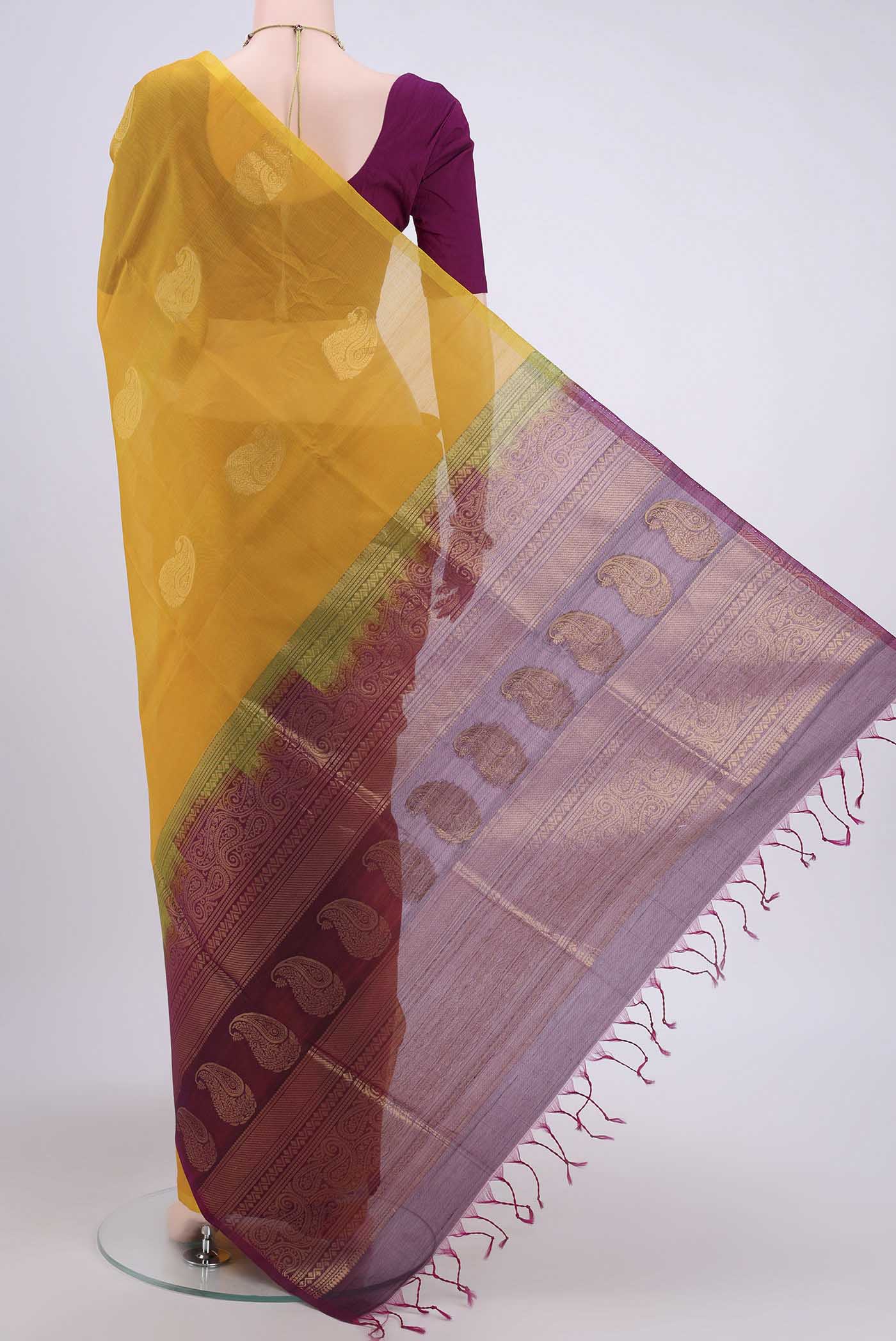 Flat view of Yellow Kora Cotton Saree with Zari Butta on the body and Zari Border. 
