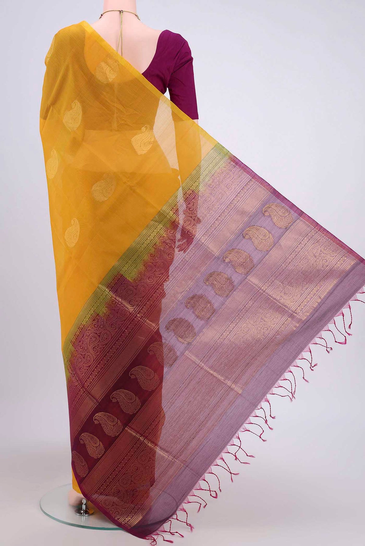 Flat view of Yellow Kora Cotton Saree with Zari Butta on the body and Zari Border. 