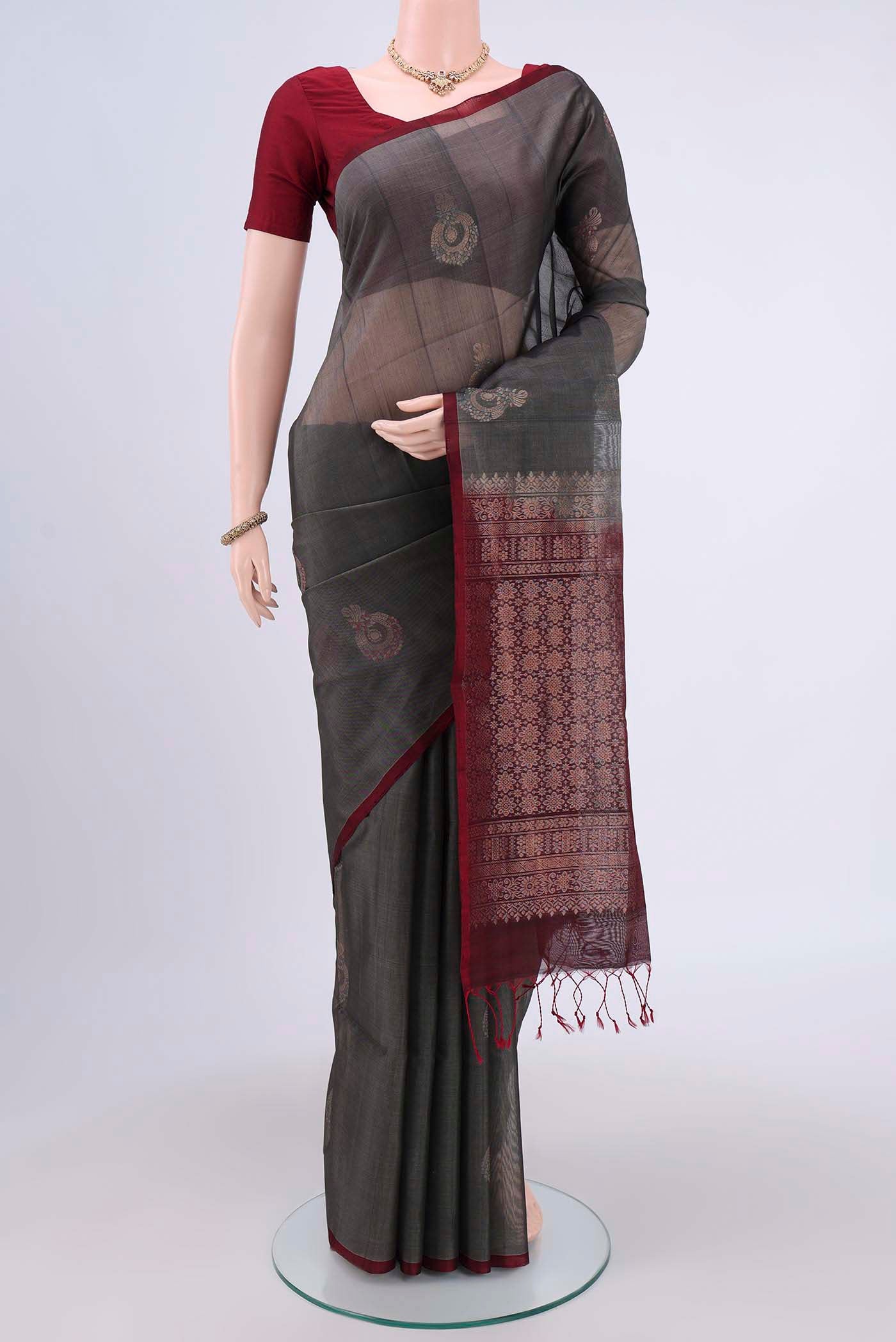 Grey Kora Cotton Saree with Zari Butta on the body and Zari Border.  displayed on a mannequin