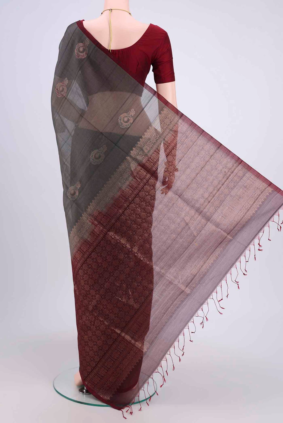 Flat view of Grey Kora Cotton Saree with Zari Butta on the body and Zari Border. 