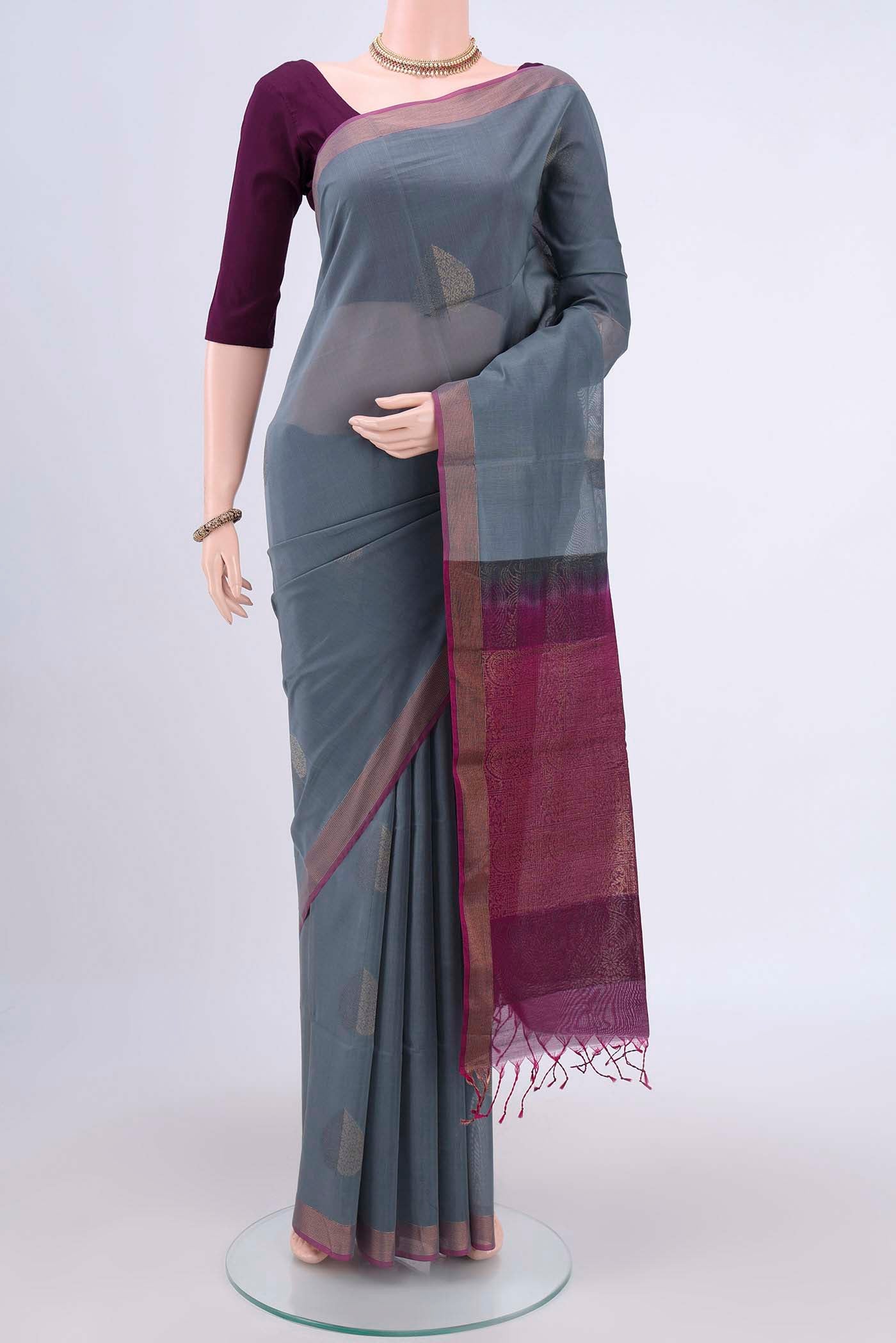 Grey Kora Cotton Saree with Zari Butta on the body and Zari Border.  displayed on a mannequin