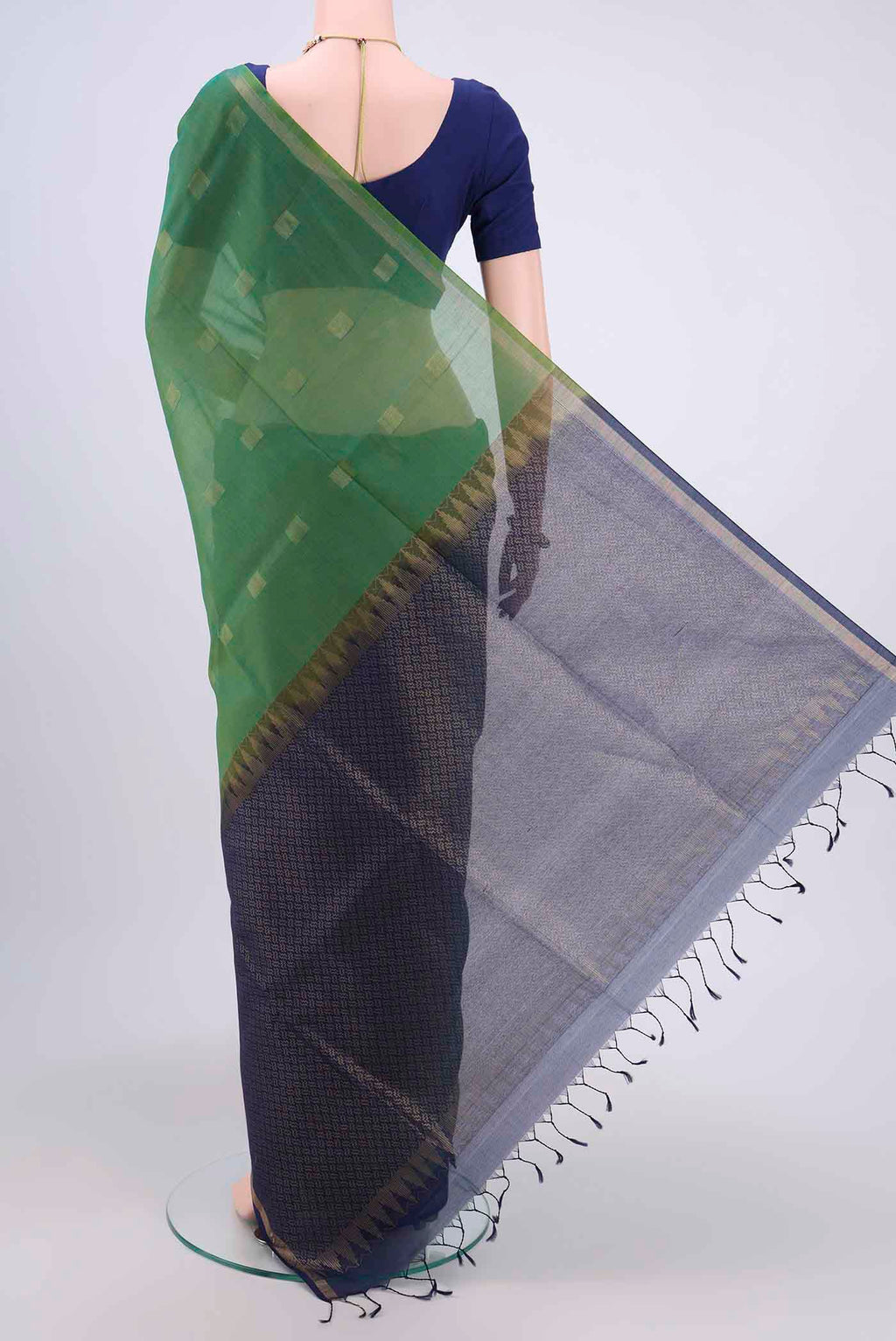 Flat view of Green Kora Cotton Saree with Zari Butta on the body and Zari Border. 
