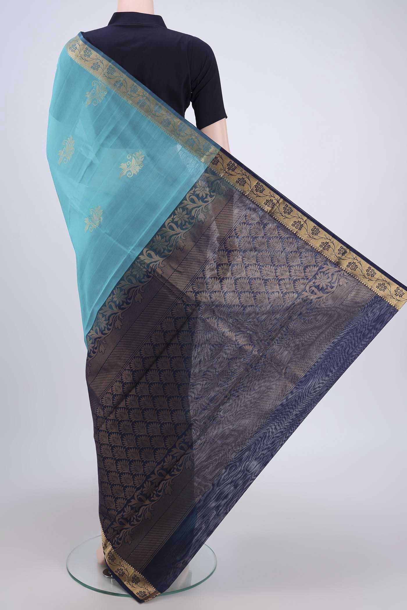 Flat view of Turquoise Silk Cotton Saree with Zari Butta on the body and Zari Border. 