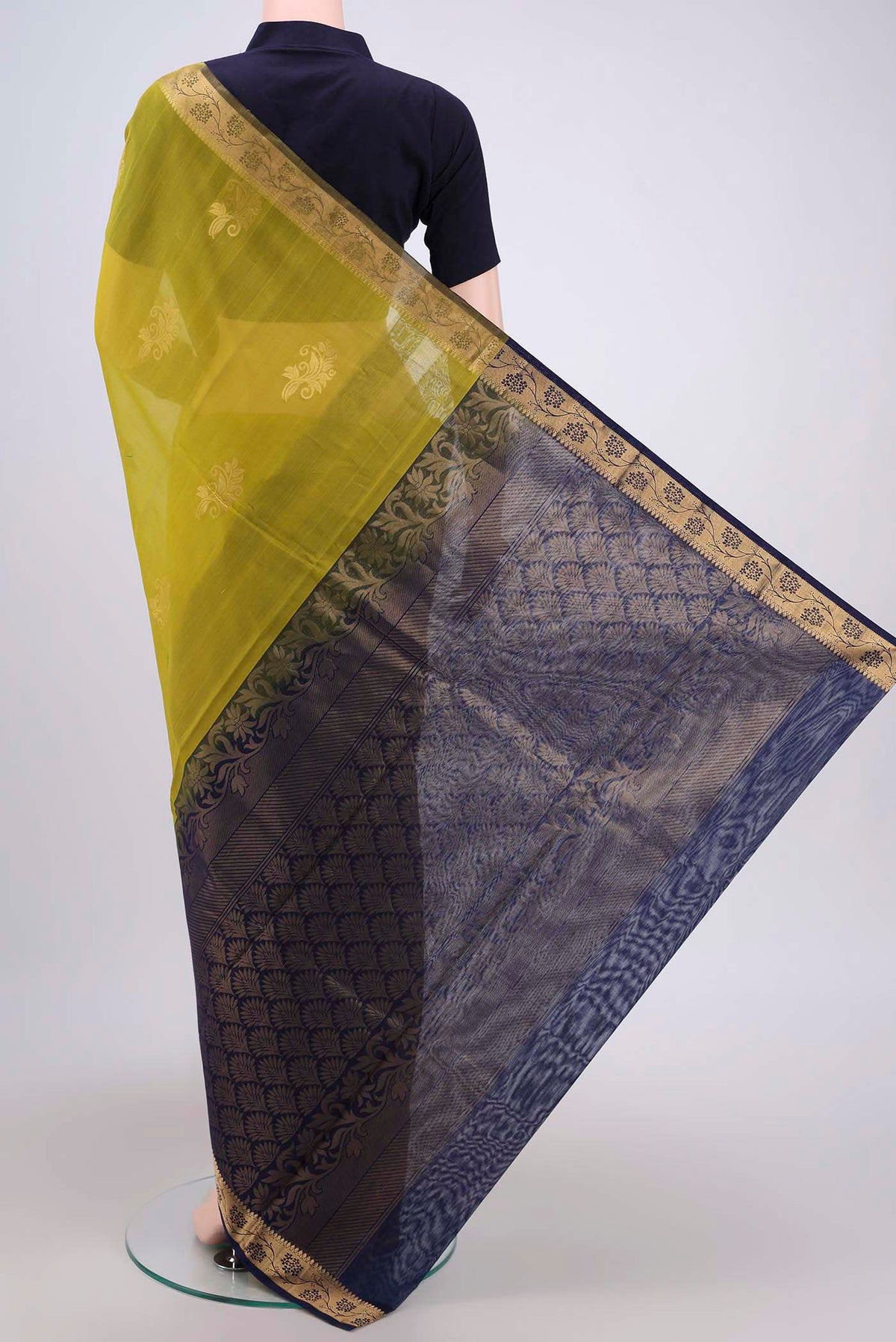 Flat view of Acid Green Silk Cotton Saree with Zari Butta on the body and Zari Border. 