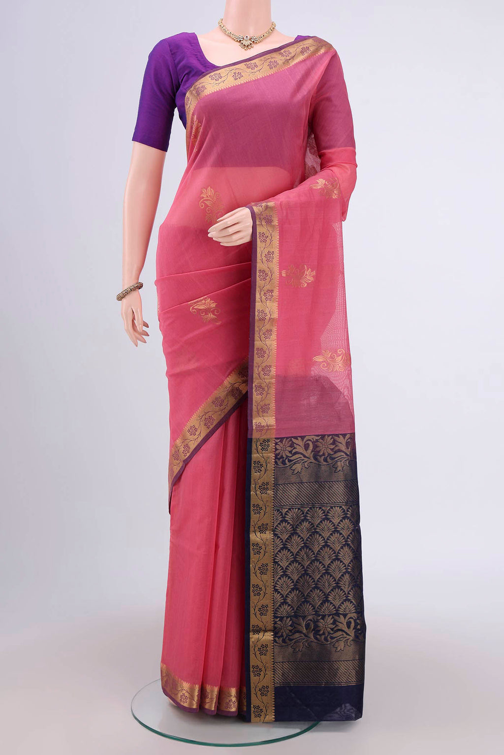 Pink Silk Cotton Saree with Zari Butta on the body and Zari Border.  displayed on a mannequin