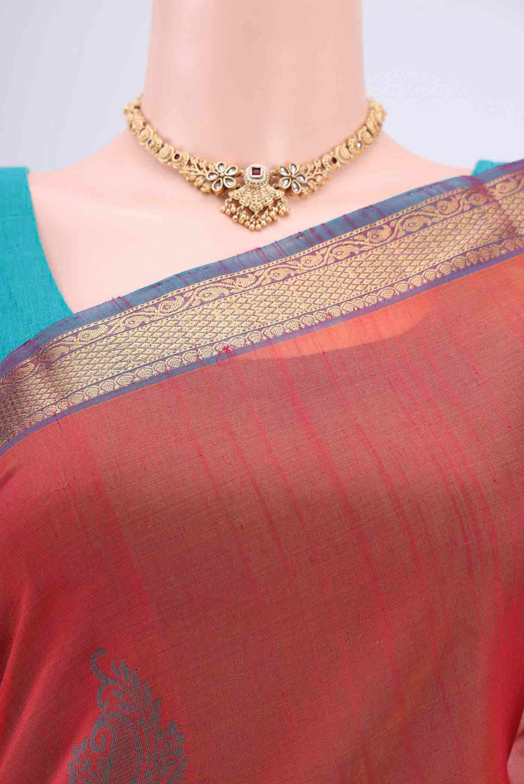 Border image of Rust Silk Cotton Saree with Zari Butta on the body and Zari Border. 