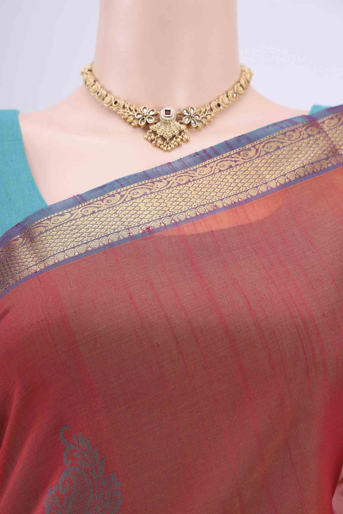 Border image of Rust Silk Cotton Saree with Zari Butta on the body and Zari Border. 
