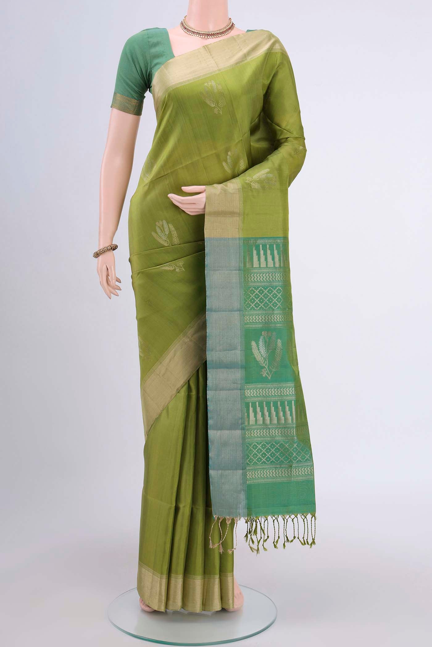 Light Green Dual Tone Soft Silk Saree with Zari Butta on the body and Zari Border displayed on a mannequin