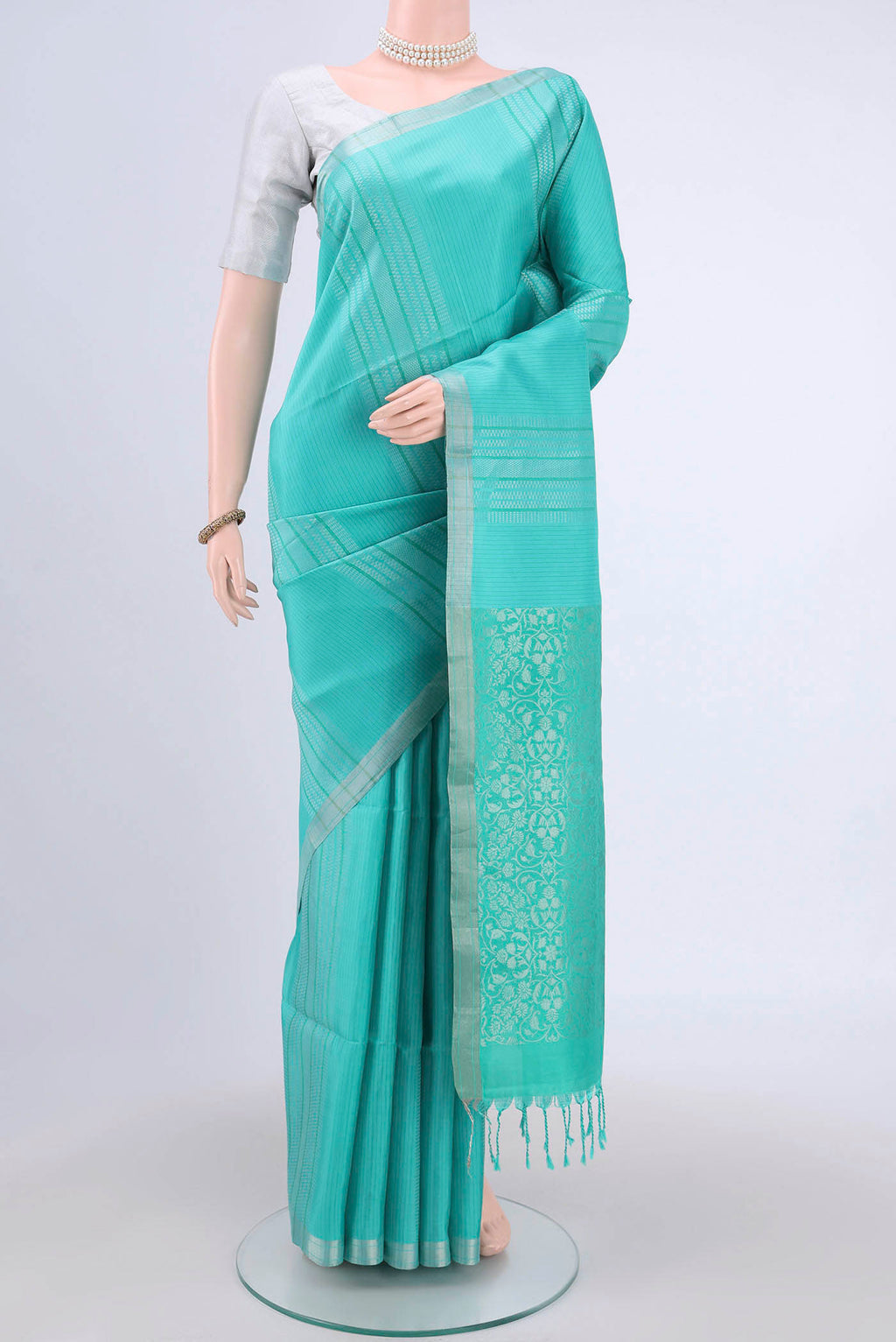 Sea Green Soft Silk Saree with Stripes on the body and Zari Border.  displayed on a mannequin