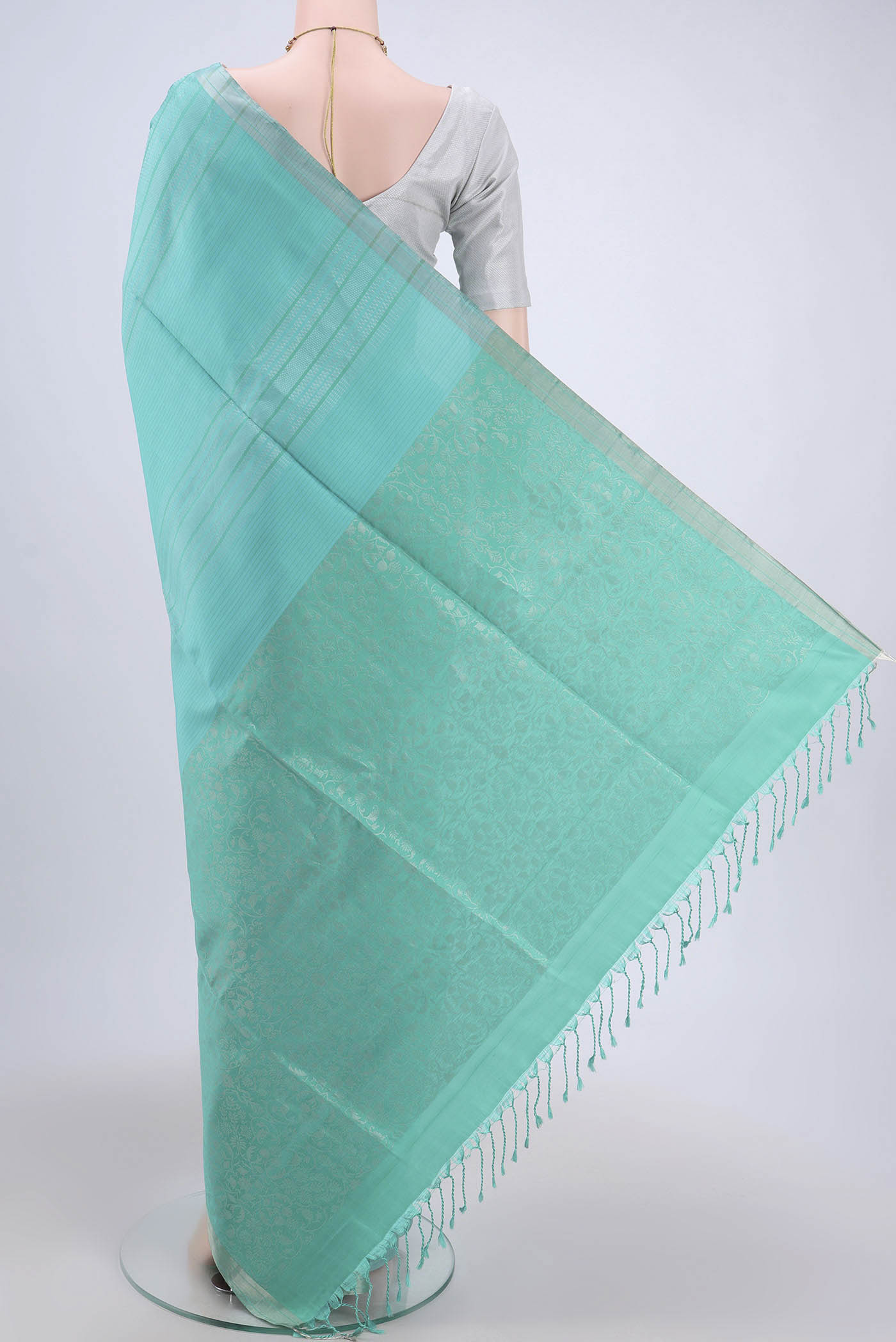 Flat view of Sea Green Soft Silk Saree with Stripes on the body and Zari Border. 
