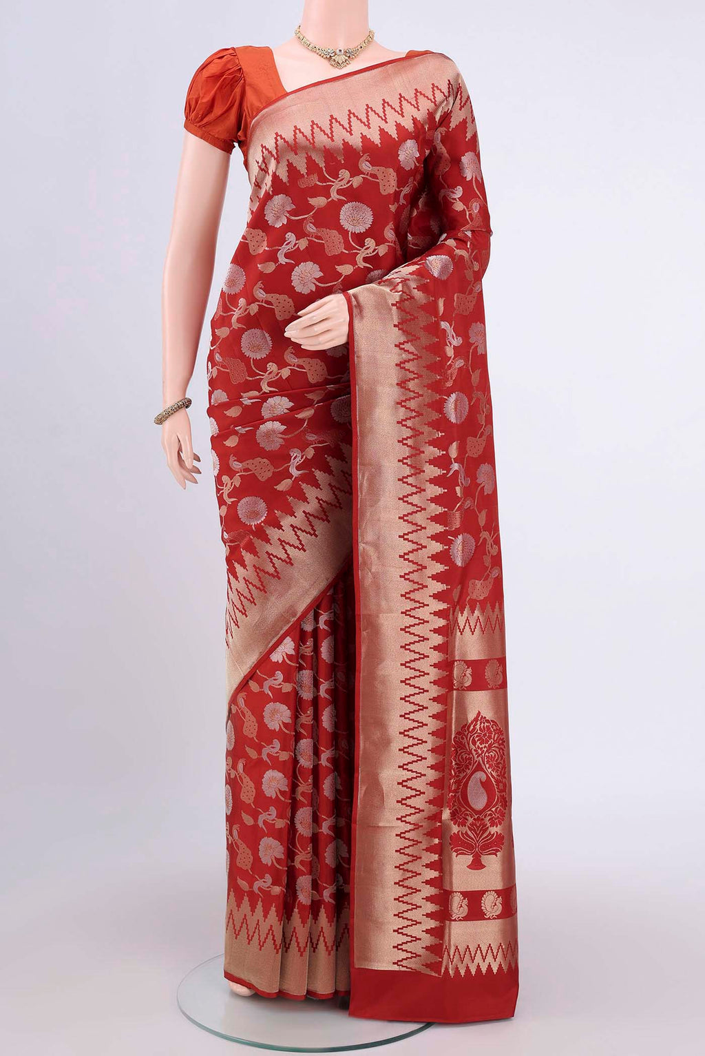 Rust Soft Silk Saree with Zari Brocade on the body and Zari Border.  displayed on a mannequin
