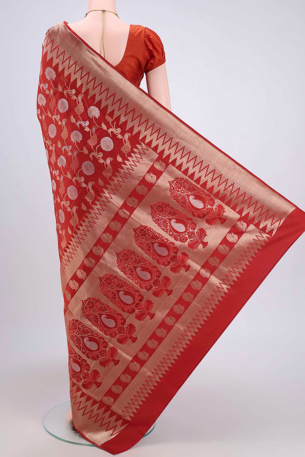 Flat view of Rust Soft Silk Saree with Zari Brocade on the body and Zari Border. 