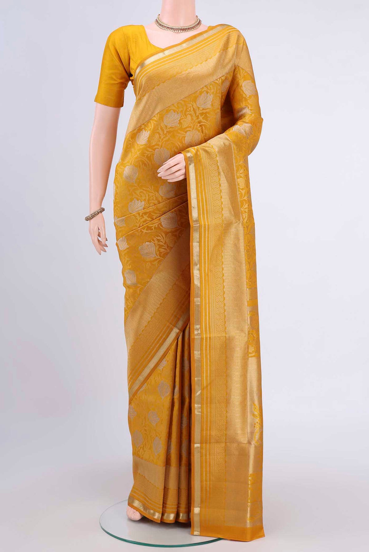 Yellow Soft Silk Saree with Zari Brocade on the body and Zari Border displayed on a mannequin