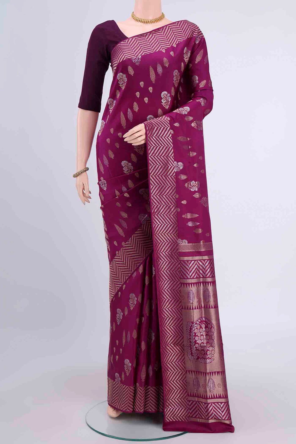 Magenta Soft Silk Saree with Zari Butta on the body and Fancy Border displayed on a mannequin