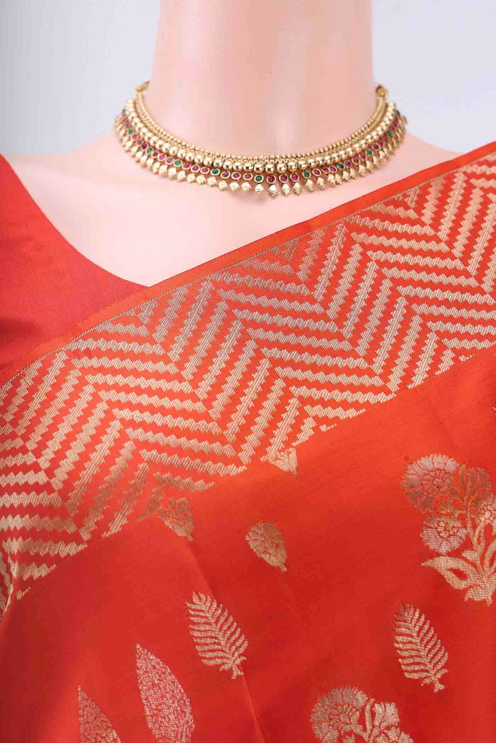 Border image of Orange Soft Silk Saree with Zari Butta on the body and Zari Border
