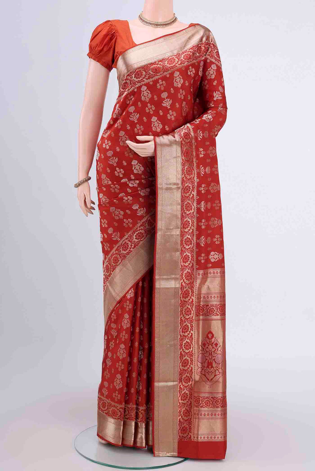 Rust Soft Silk Saree with Zari Butta on the body and Zari Border displayed on a mannequin