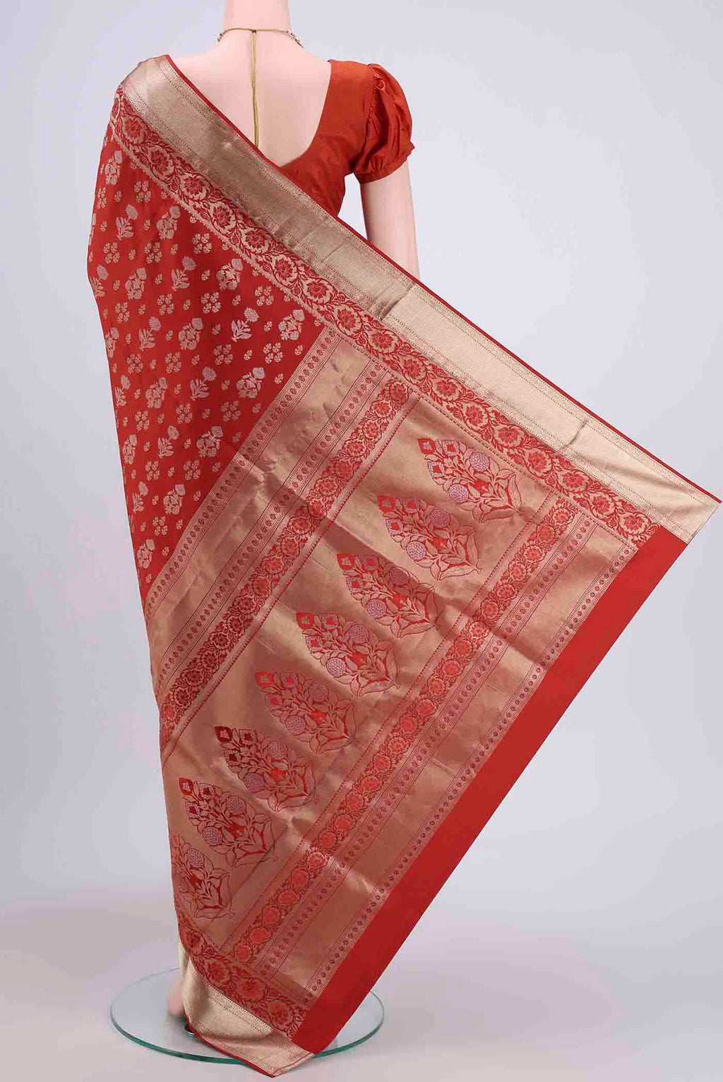 Flat view of Rust Soft Silk Saree with Zari Butta on the body and Zari Border