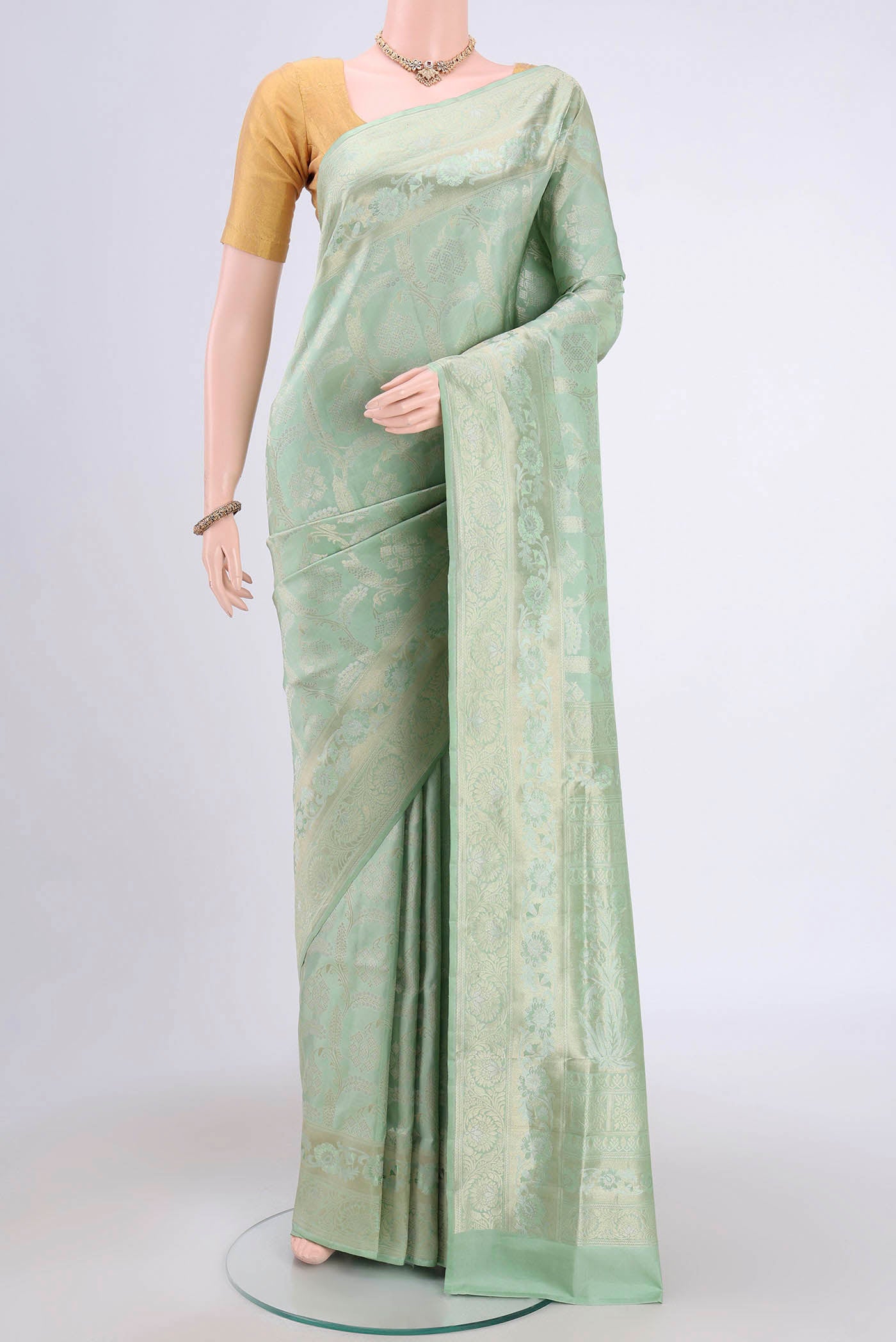 Mint Green Soft Silk Saree with Zari Brocade on the body and Zari Border.  displayed on a mannequin