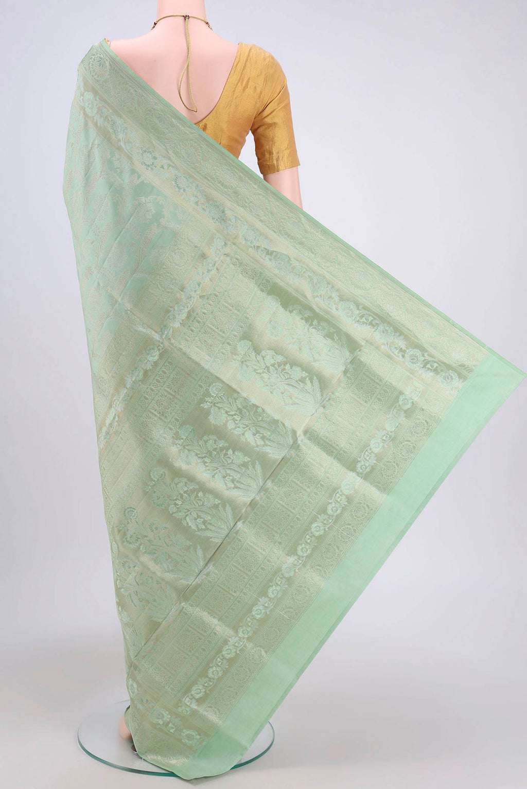 Flat view of Mint Green Soft Silk Saree with Zari Brocade on the body and Zari Border. 