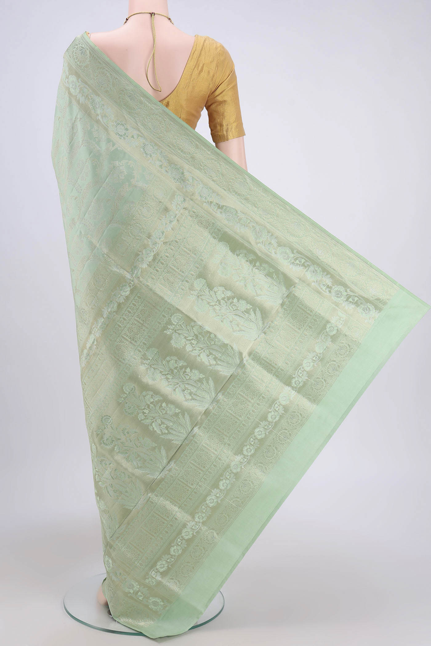 Flat view of Mint Green Soft Silk Saree with Zari Brocade on the body and Zari Border. 