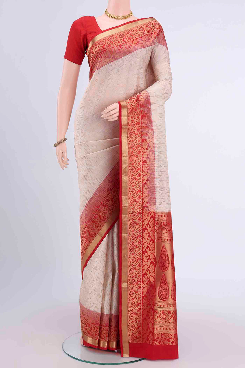 Off White Soft Silk Saree with Zari Brocade on the body and Zari Border displayed on a mannequin