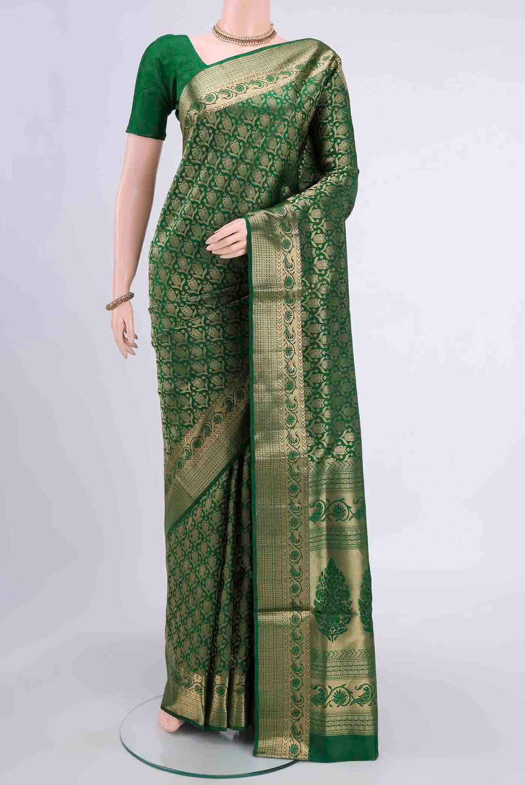 Bottle Green Soft Silk Saree with Zari Brocade on the body and Zari Border displayed on a mannequin