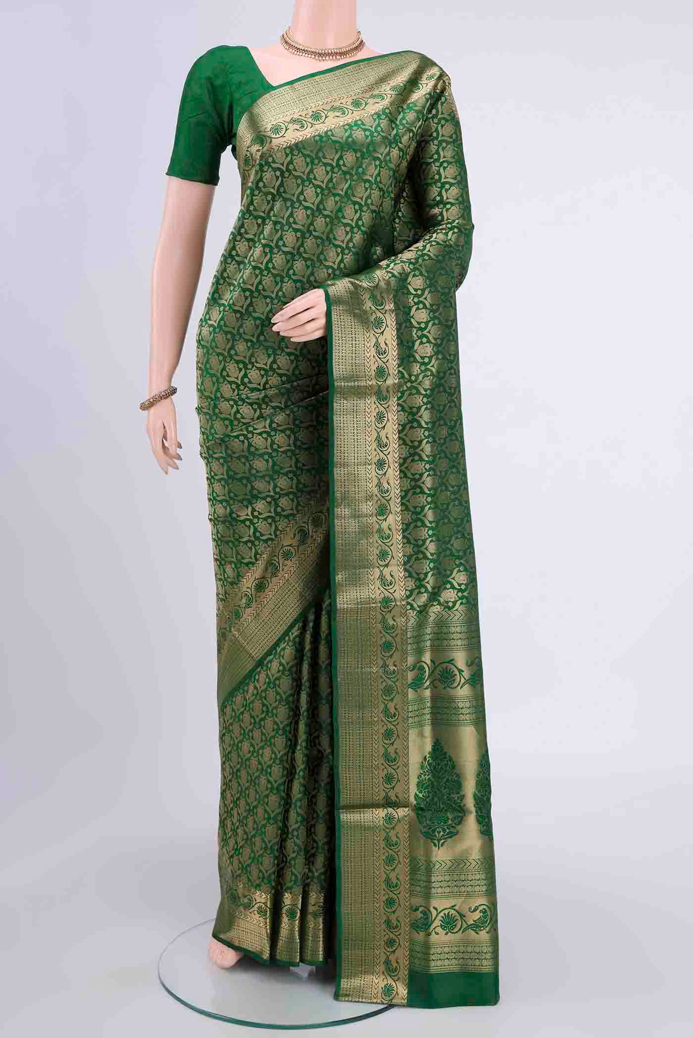 Bottle Green Soft Silk Saree with Zari Brocade on the body and Zari Border displayed on a mannequin