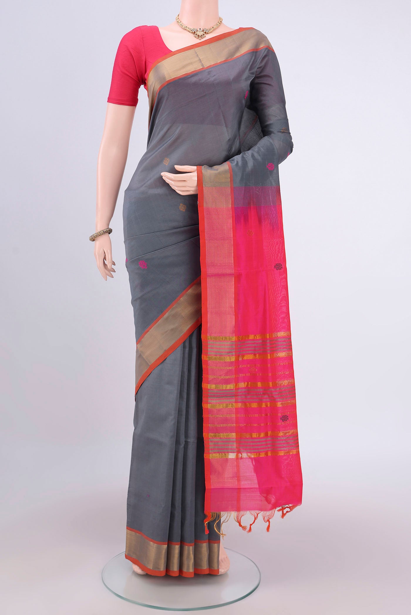 Grey Blended Poly Cotton Saree with Thread Butta on the body and Zari Border.  displayed on a mannequin