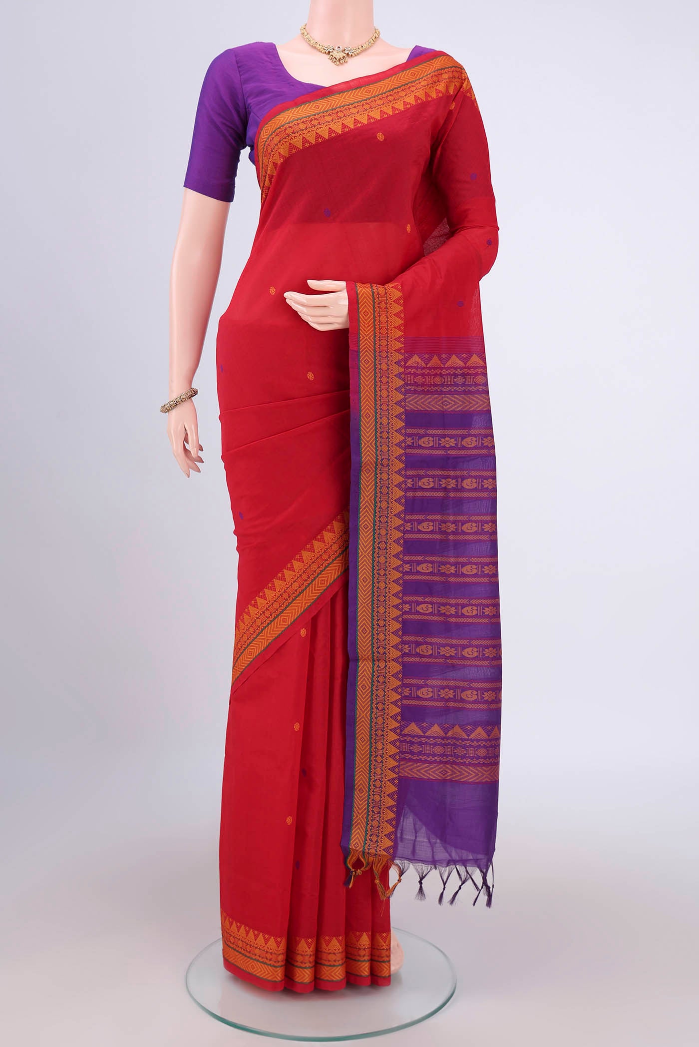 Red Blended Poly Cotton Saree with Thread Butta on the body and Thread Border.  displayed on a mannequin