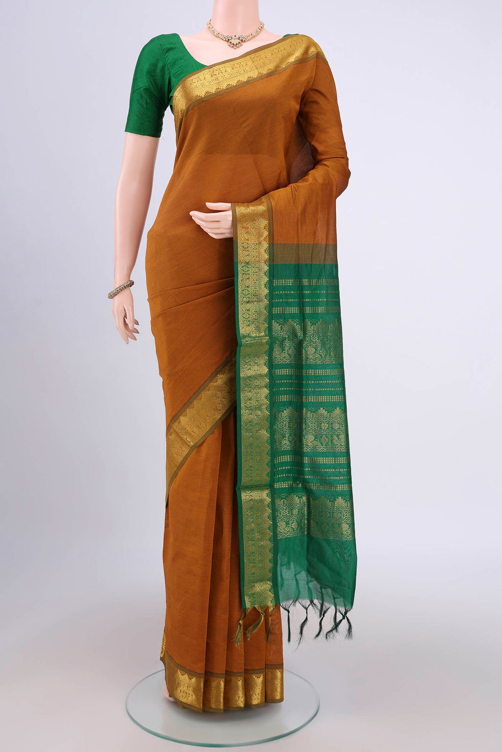 Mustard Blended Poly Cotton Saree with Plain Body and Zari Border.  displayed on a mannequin